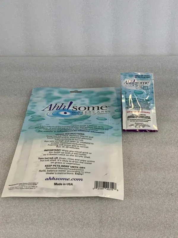 A package of toothpaste and a toothbrush on the counter.