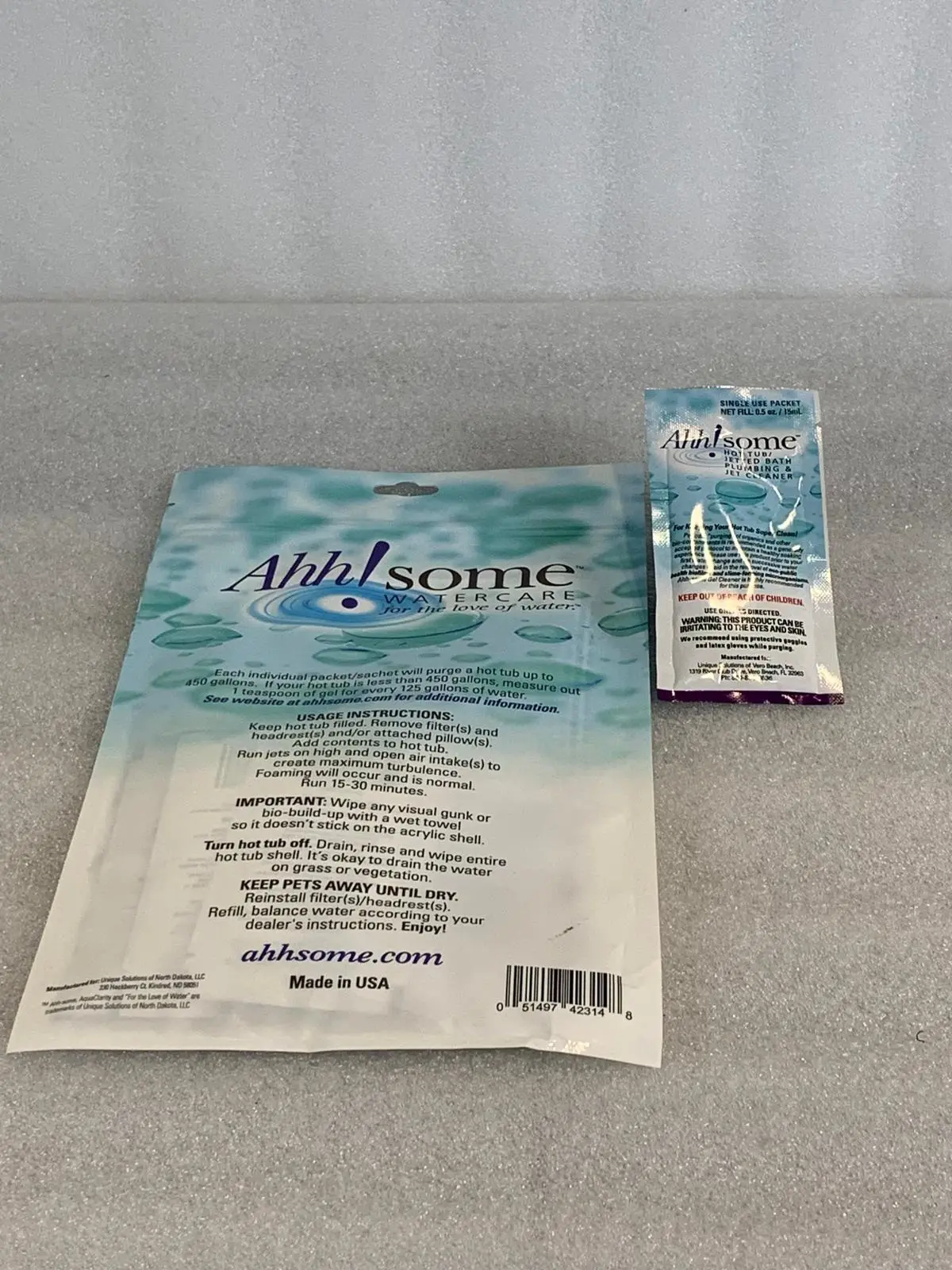 A package of toothpaste and a toothbrush on the counter.
