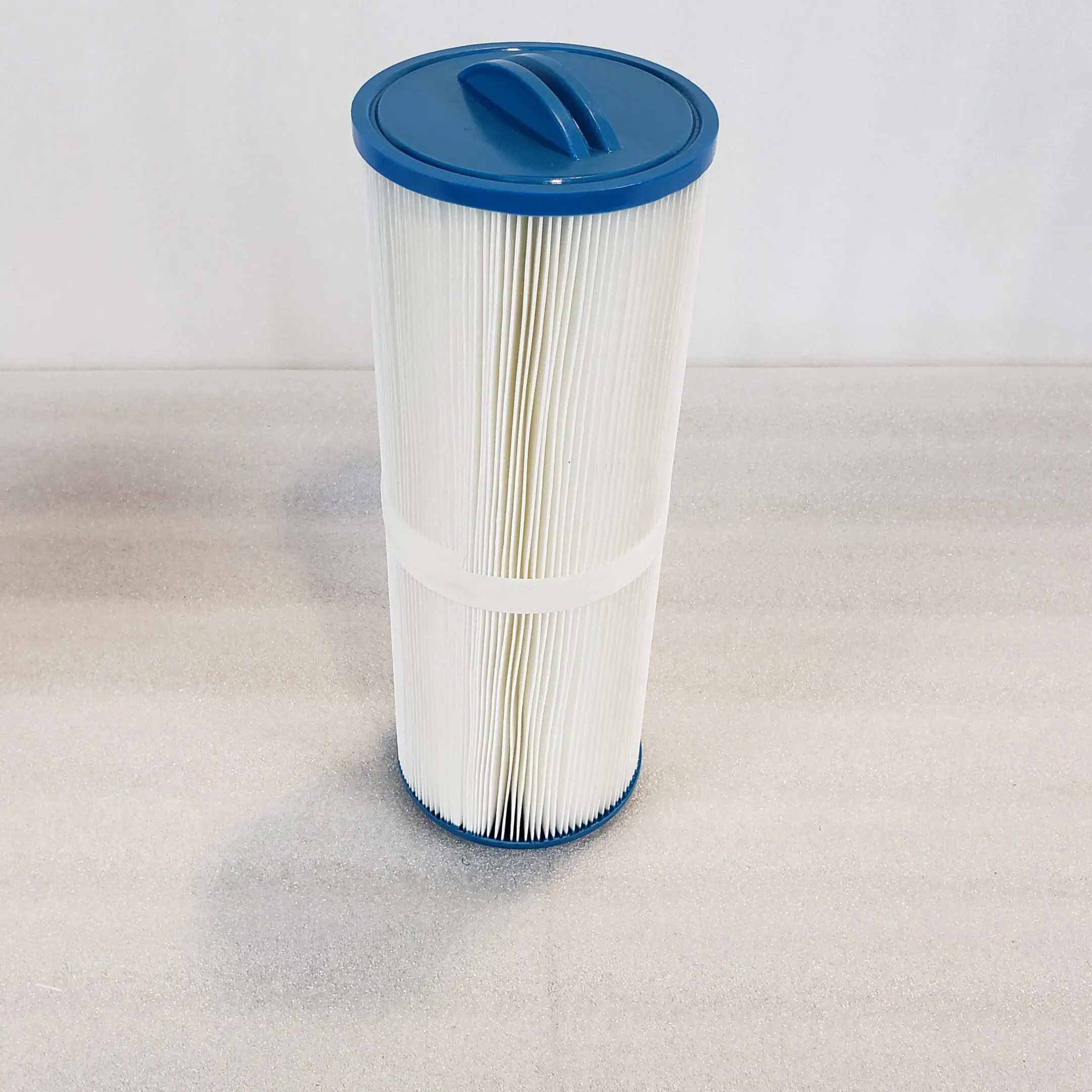 A pool filter sitting on top of a table.