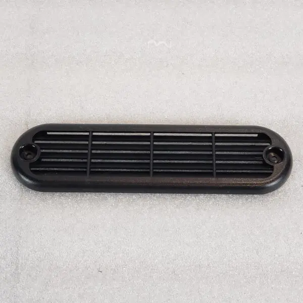 A black plastic air vent on the floor.