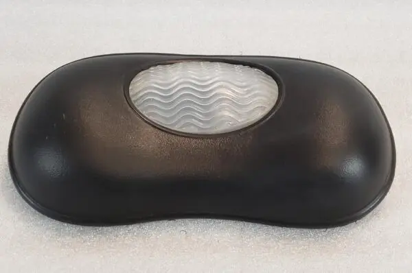 A black pillow with a white wave pattern on it.