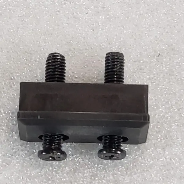 A black piece of metal with two bolts on it.