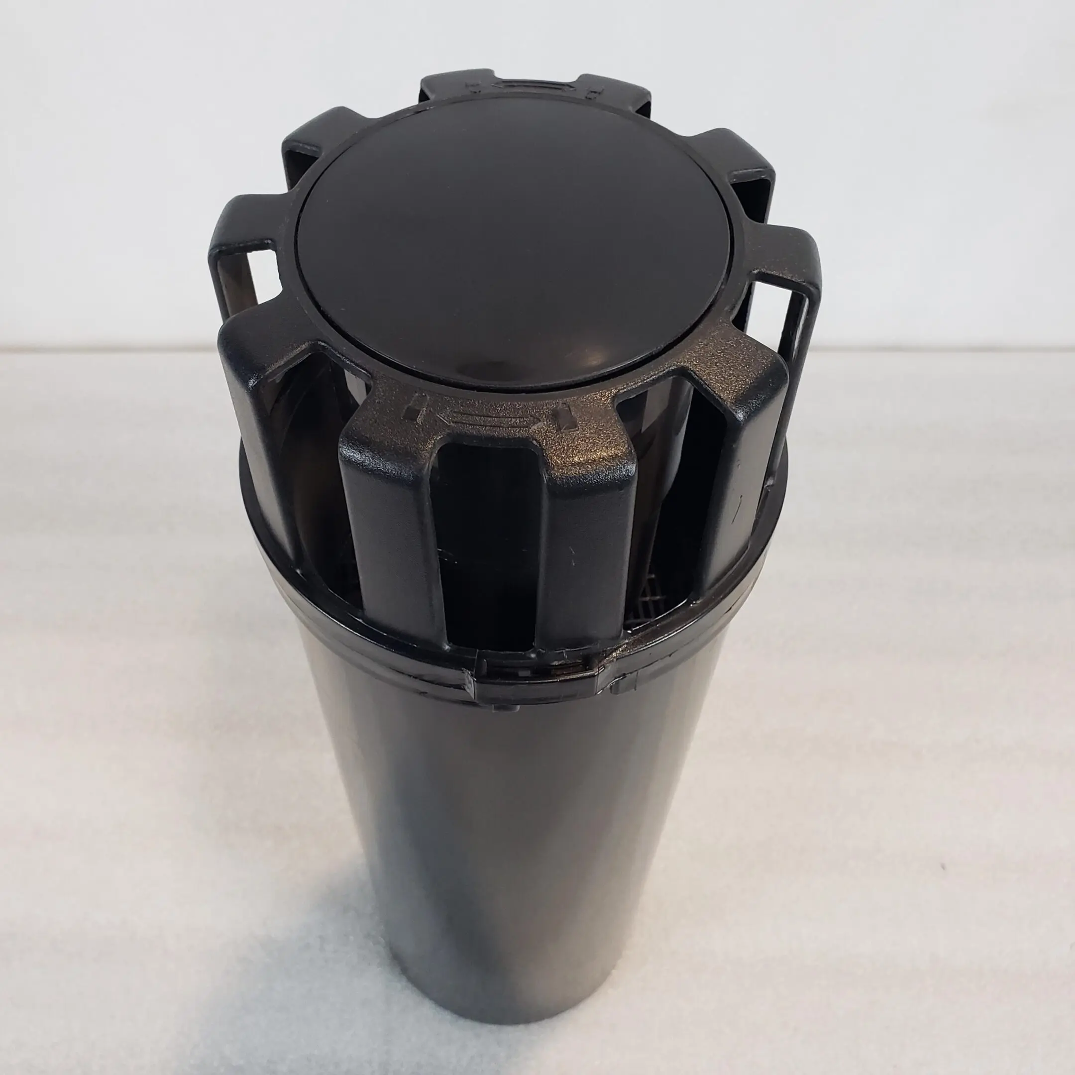 A black container with a lid on top of it.