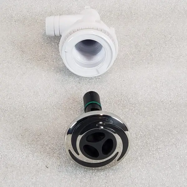 A white and black faucet with a chrome knob.