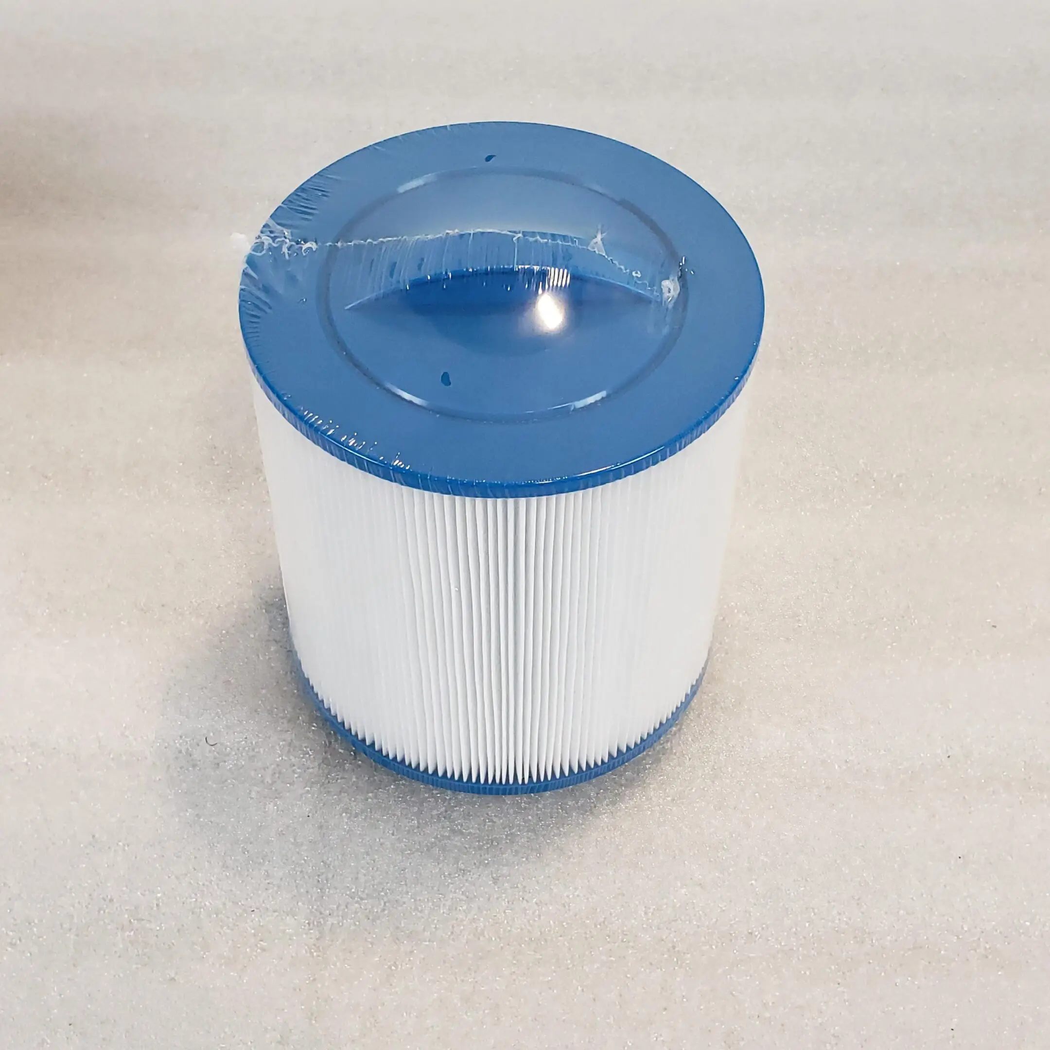 A blue and white filter sitting on top of a table.