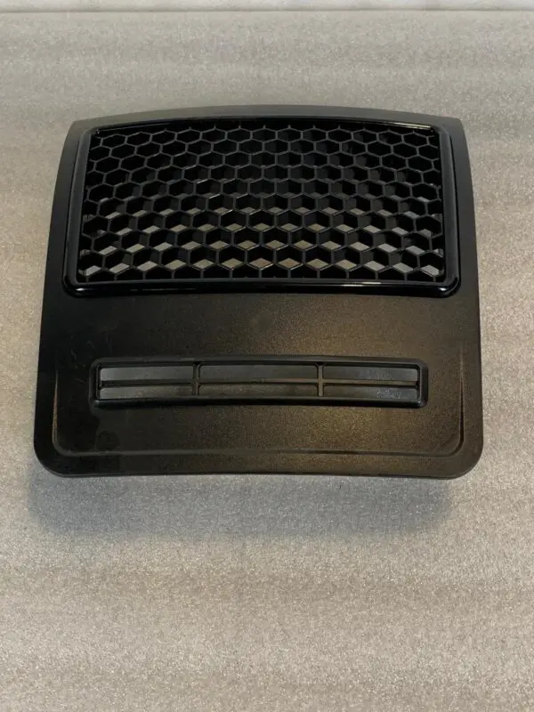A black plastic object sitting on top of a table.