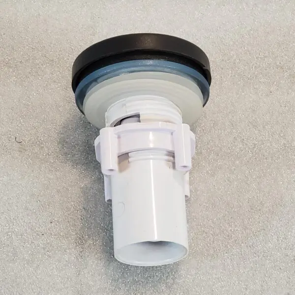 A white toilet tank flush valve with black cap.