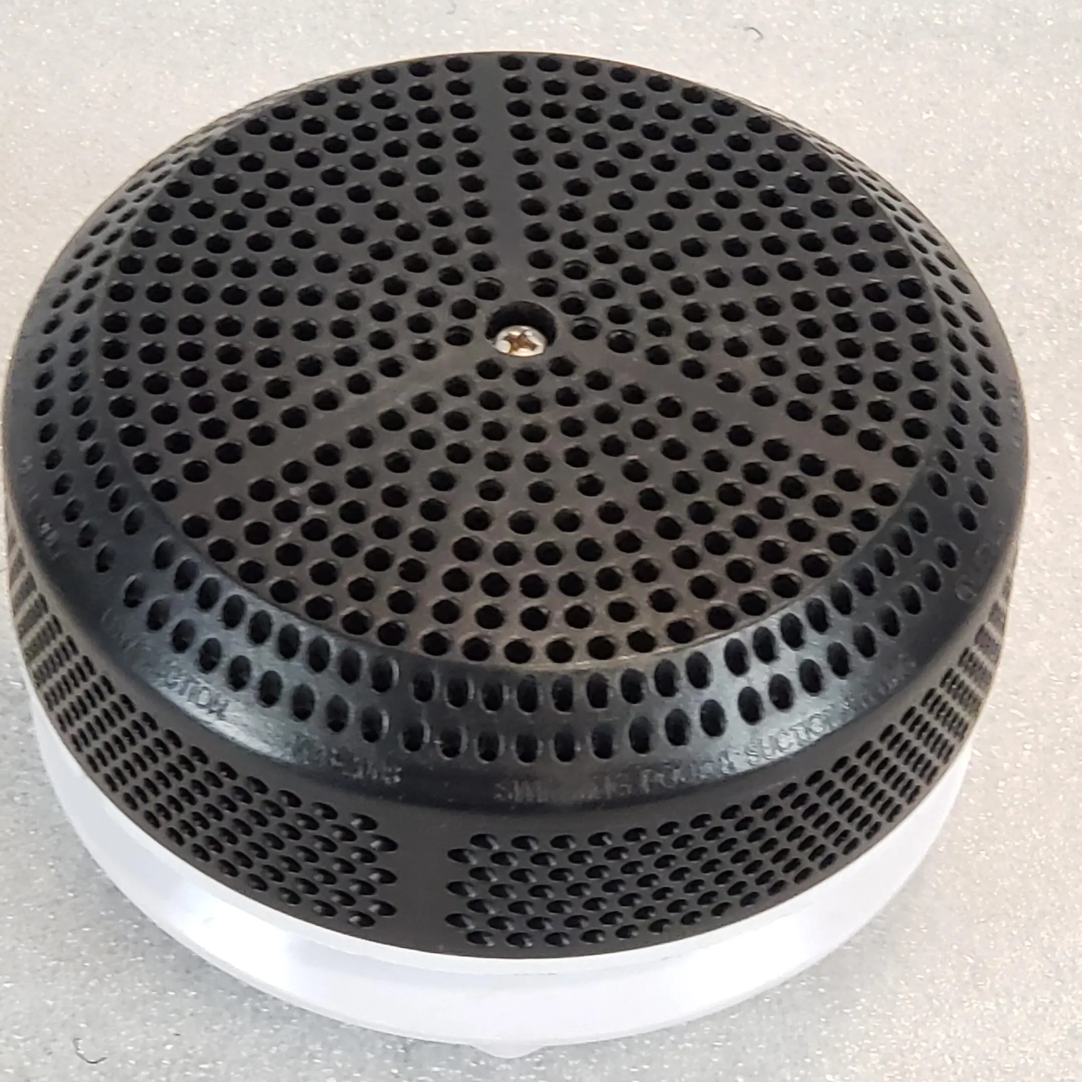 A black and white speaker sitting on top of a table.