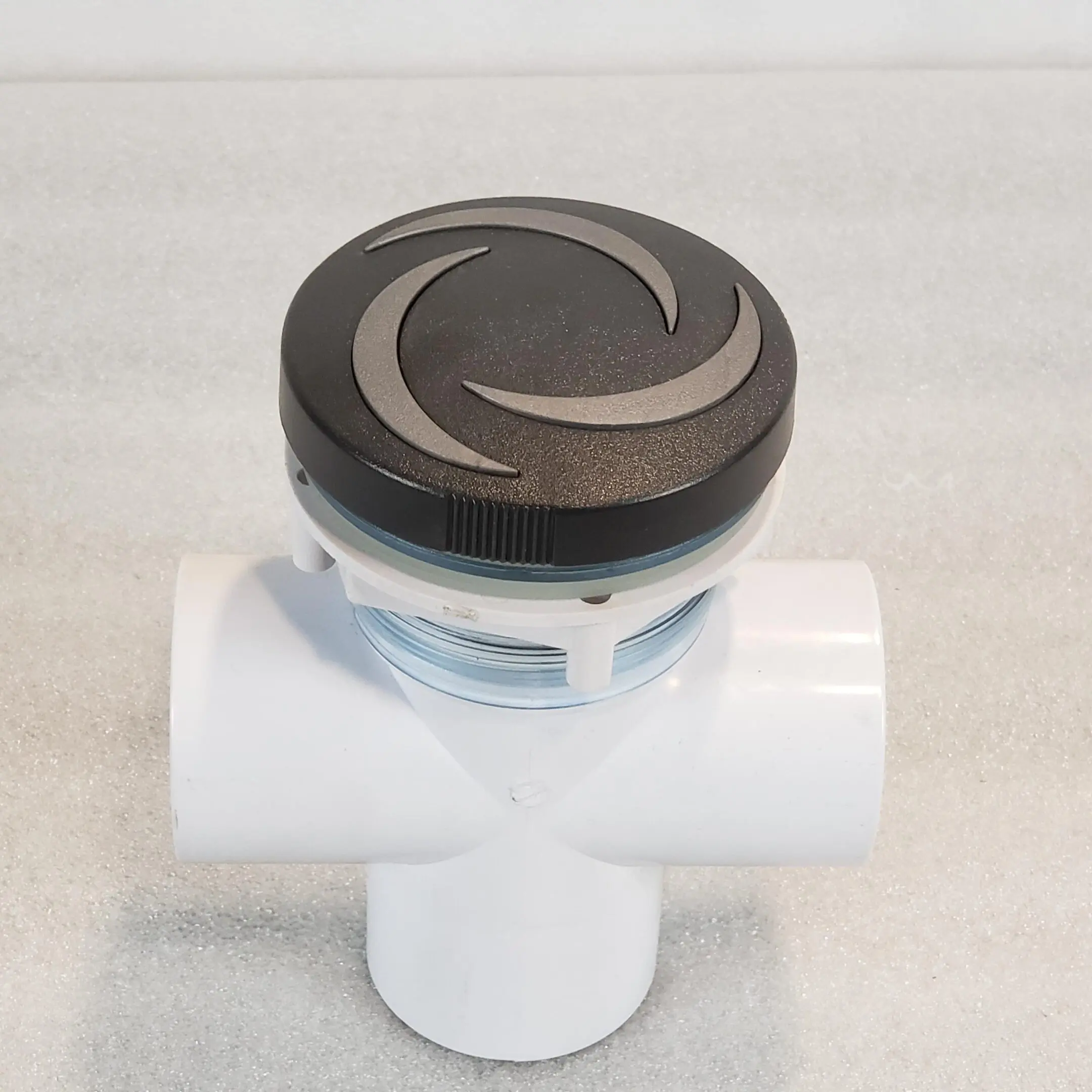 A white pipe with a black and silver lid.