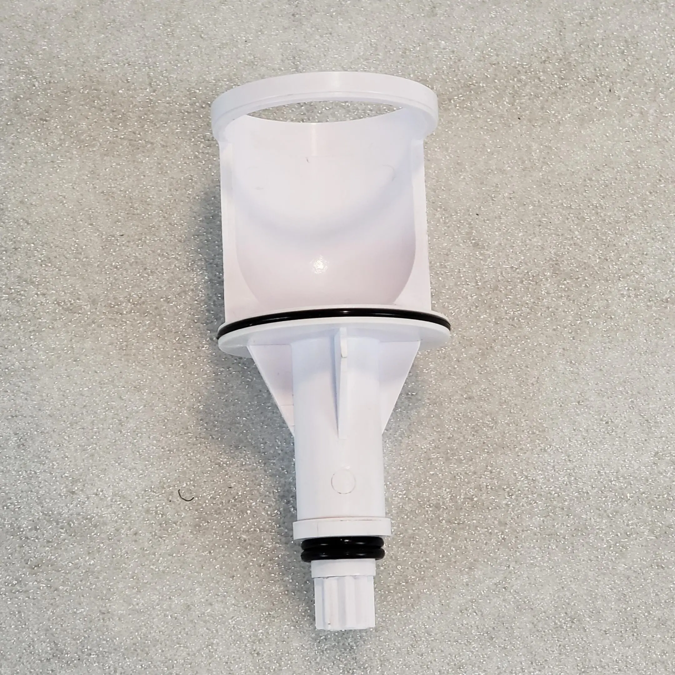 A white plastic bottle with a black cap.