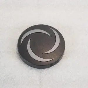 A black button with white design on it.