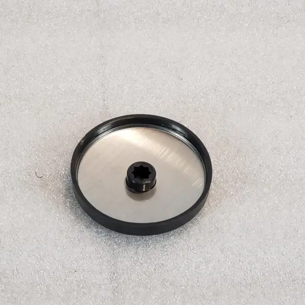 A black and silver object sitting on top of a white surface.