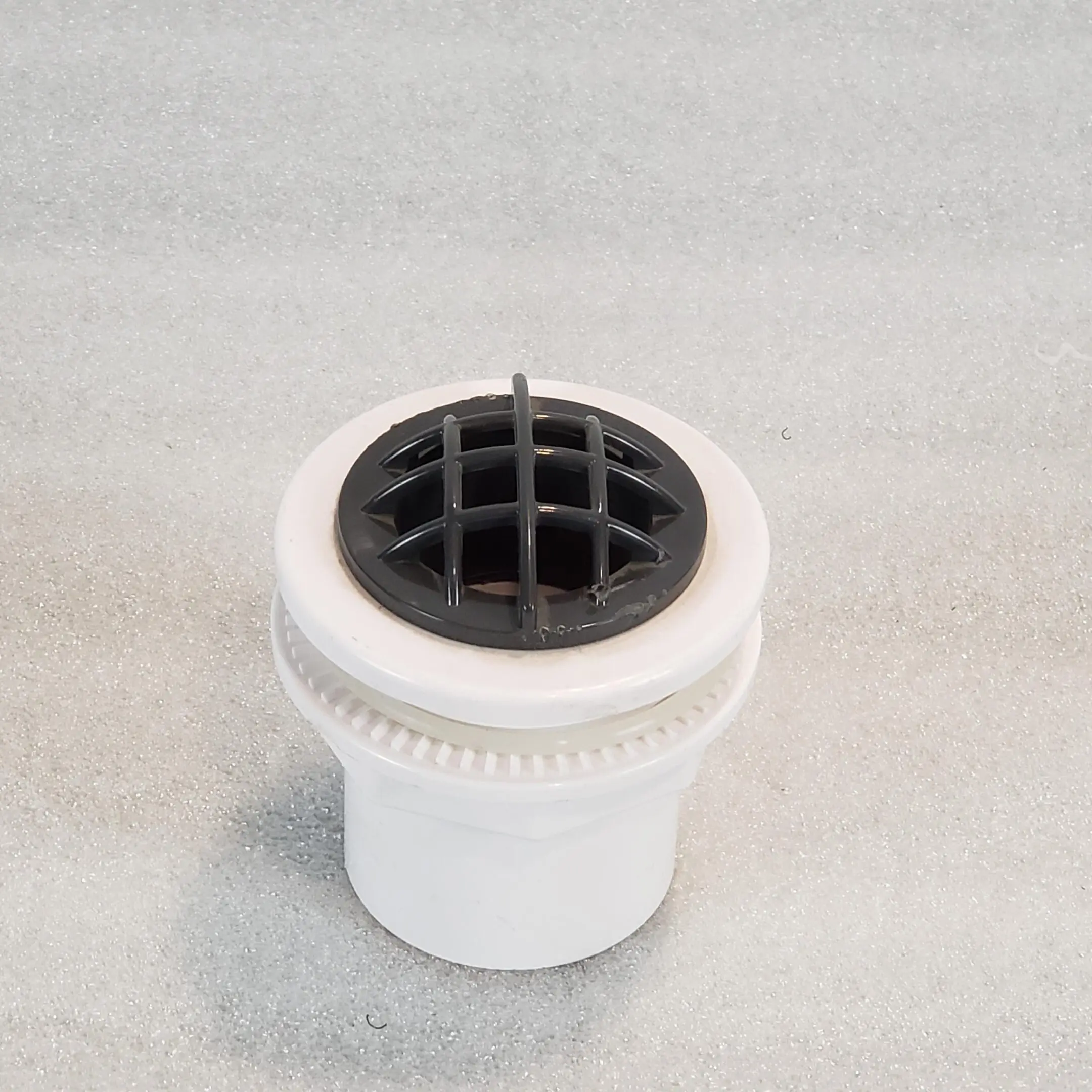 A white plastic cup with a black lid.