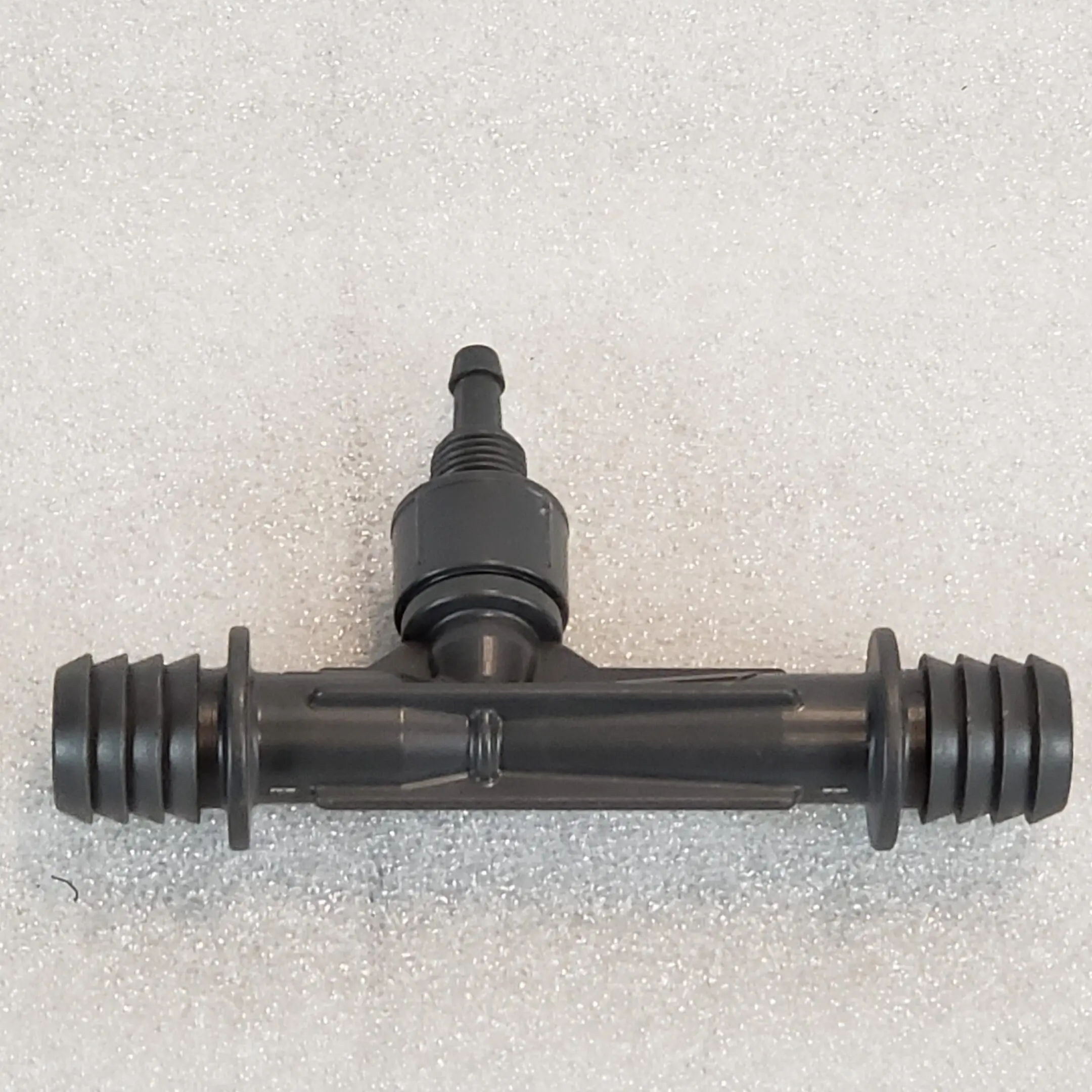 A black plastic pipe with an outlet on it.