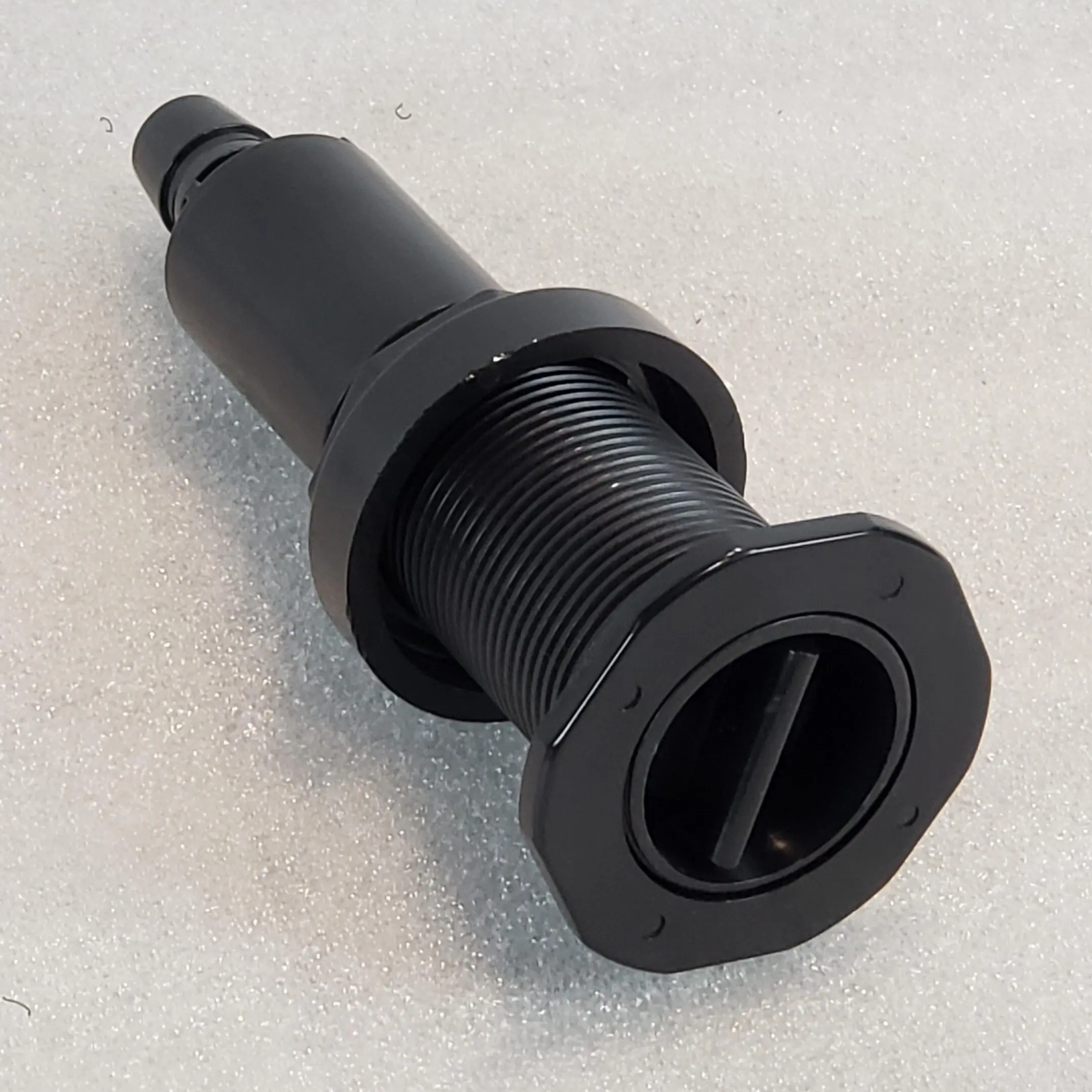 A black plastic tube with a hole in it.