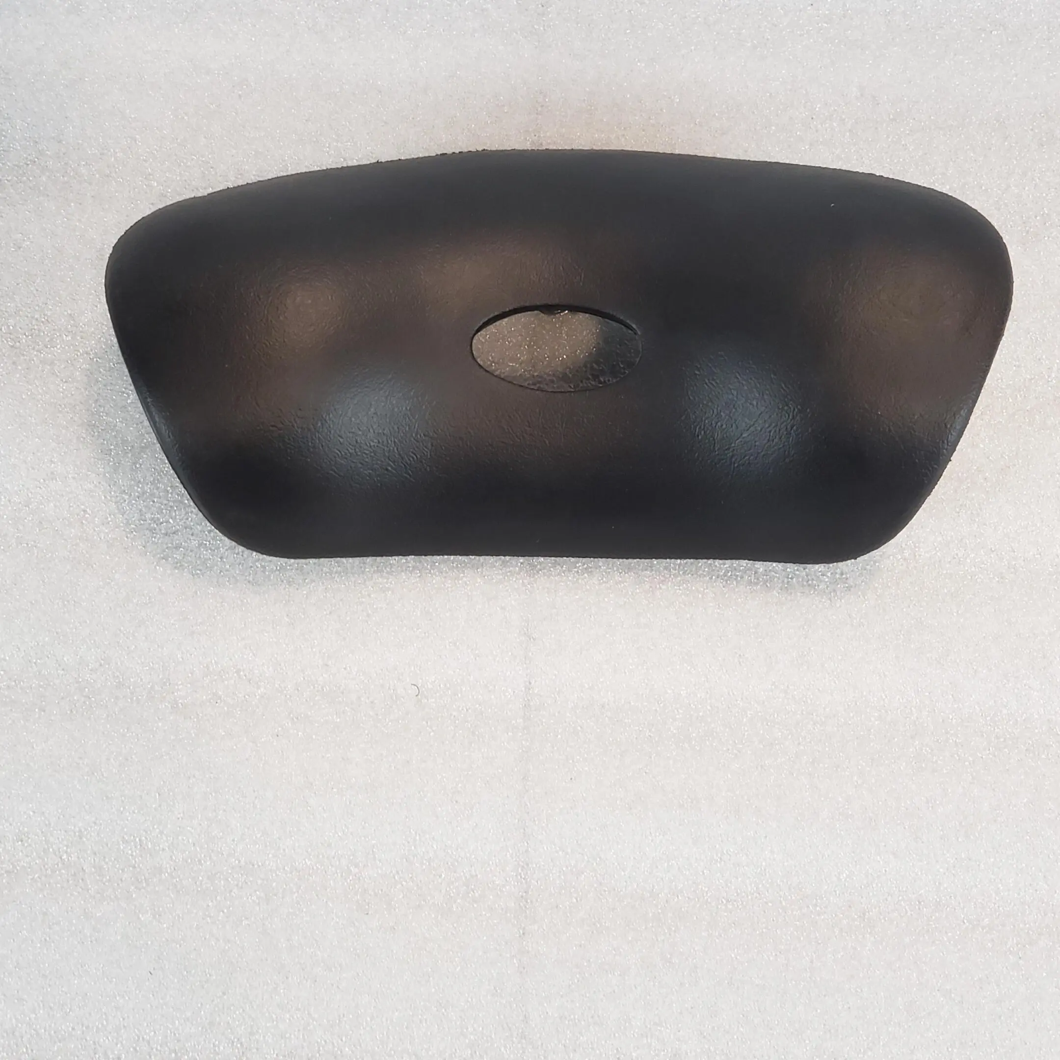 A black object is hanging on the wall.