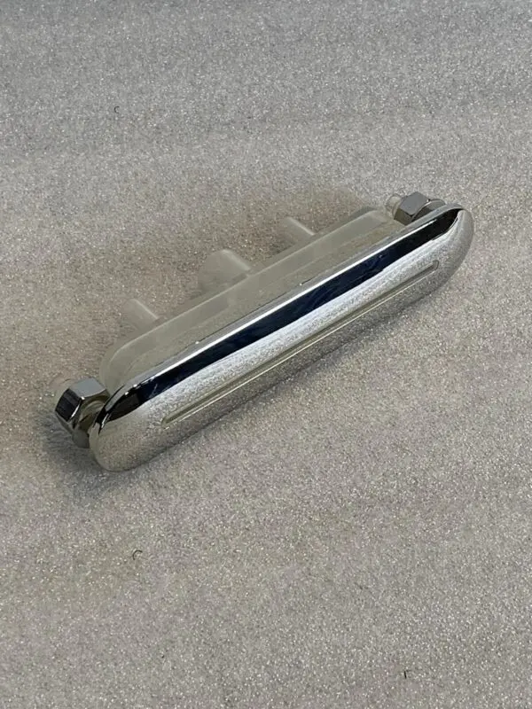 A close up of the handle on a metal object.