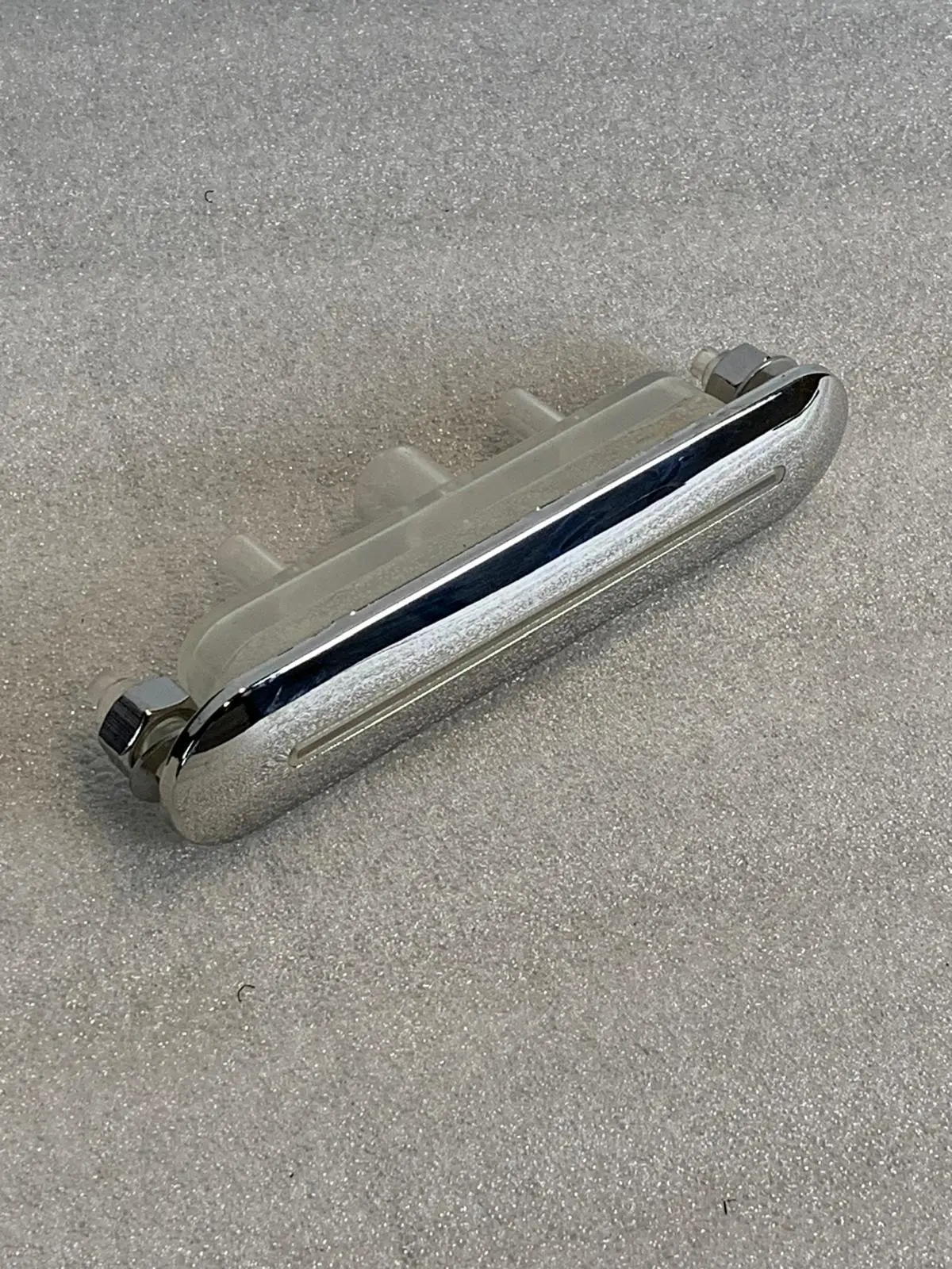 A close up of the handle on a metal object.