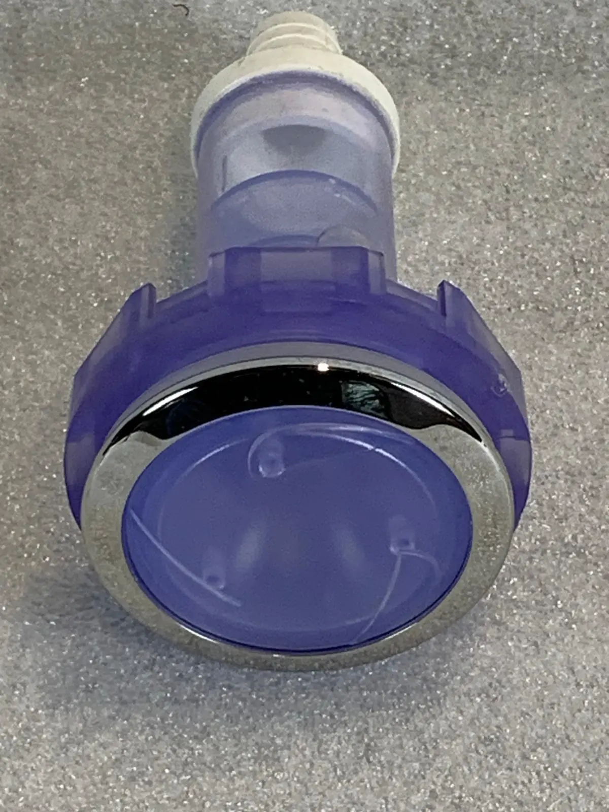 A purple and silver plastic object sitting on top of a floor.