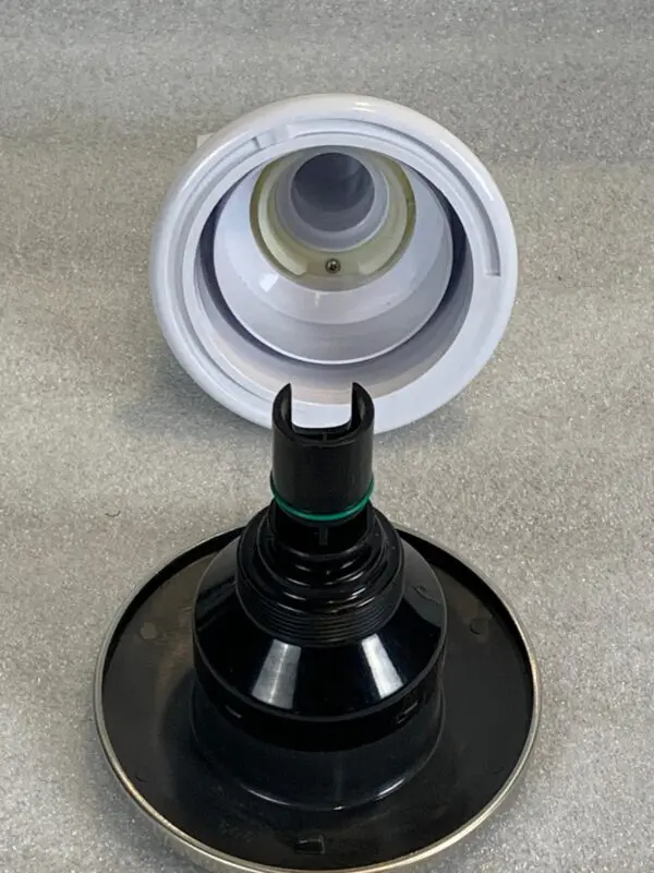 A black and white bottle sitting on top of a counter.