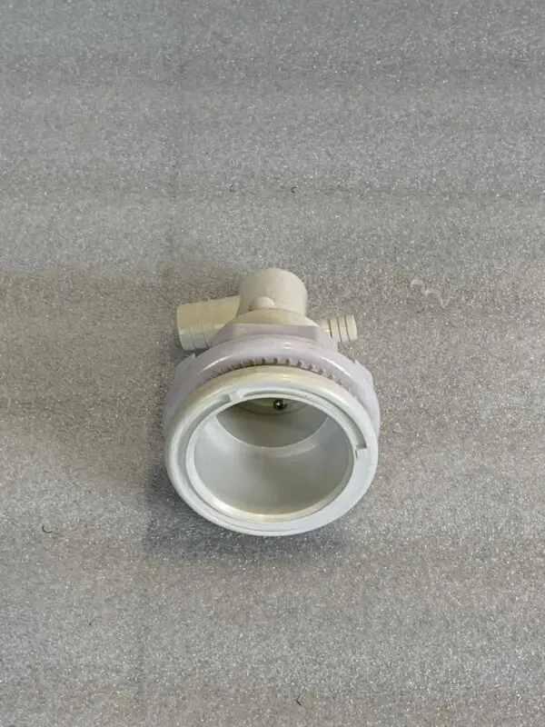 A white pipe sitting on top of a floor.