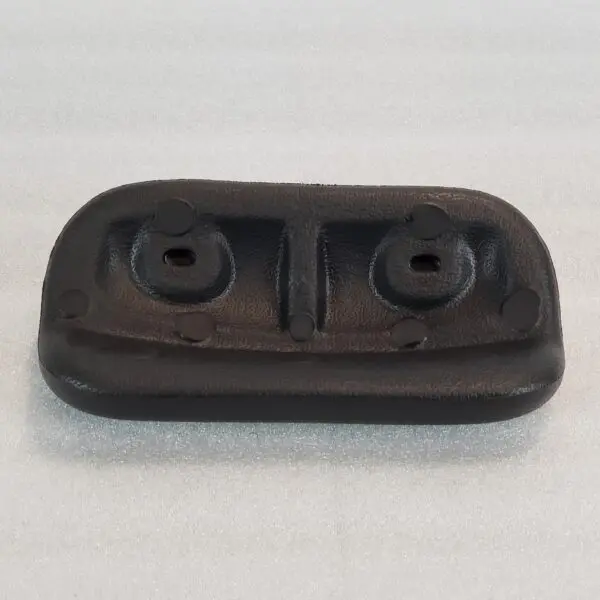 A black rubber block with two holes for the bottom.