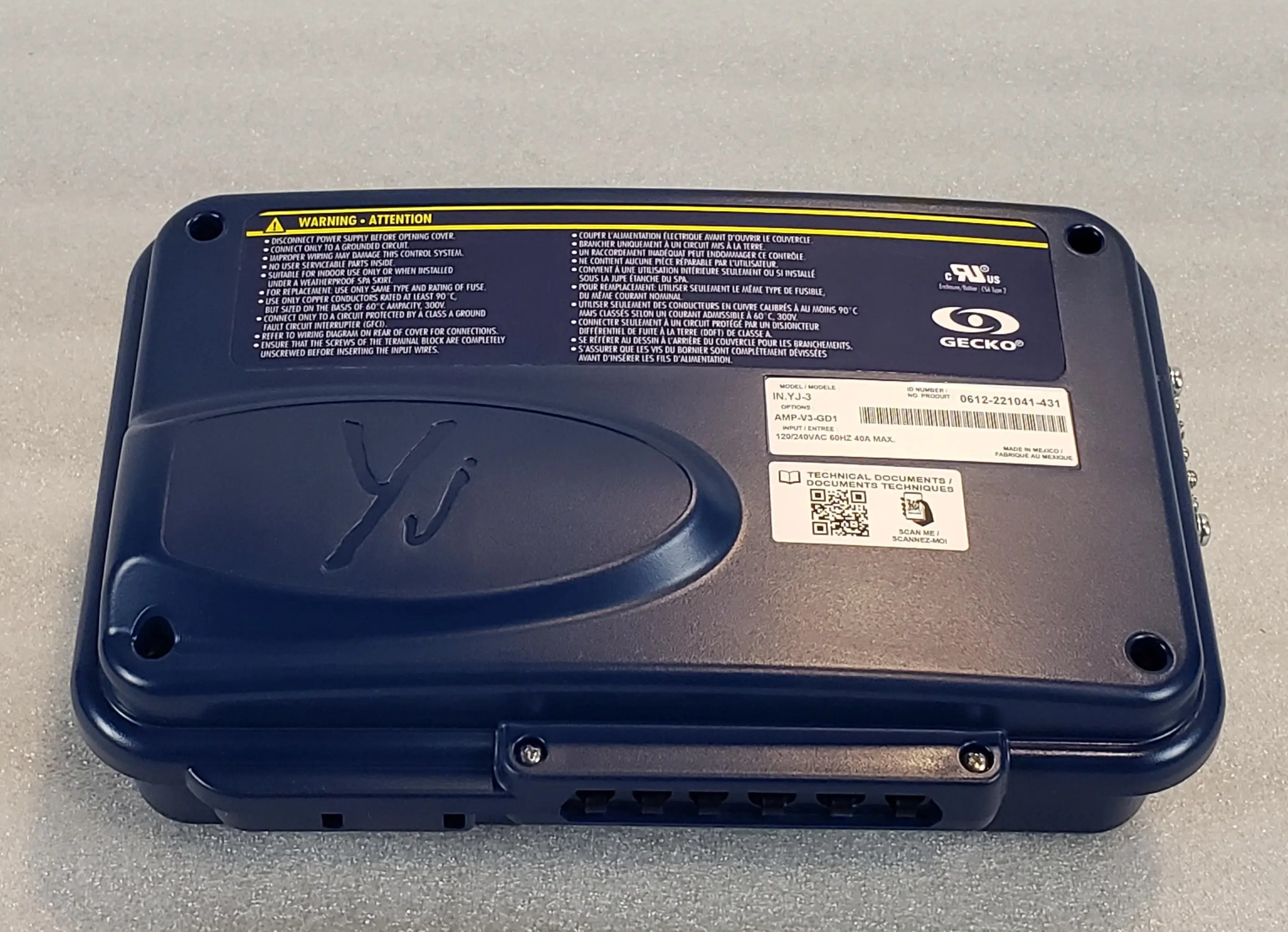 A close up of the back side of an old laptop