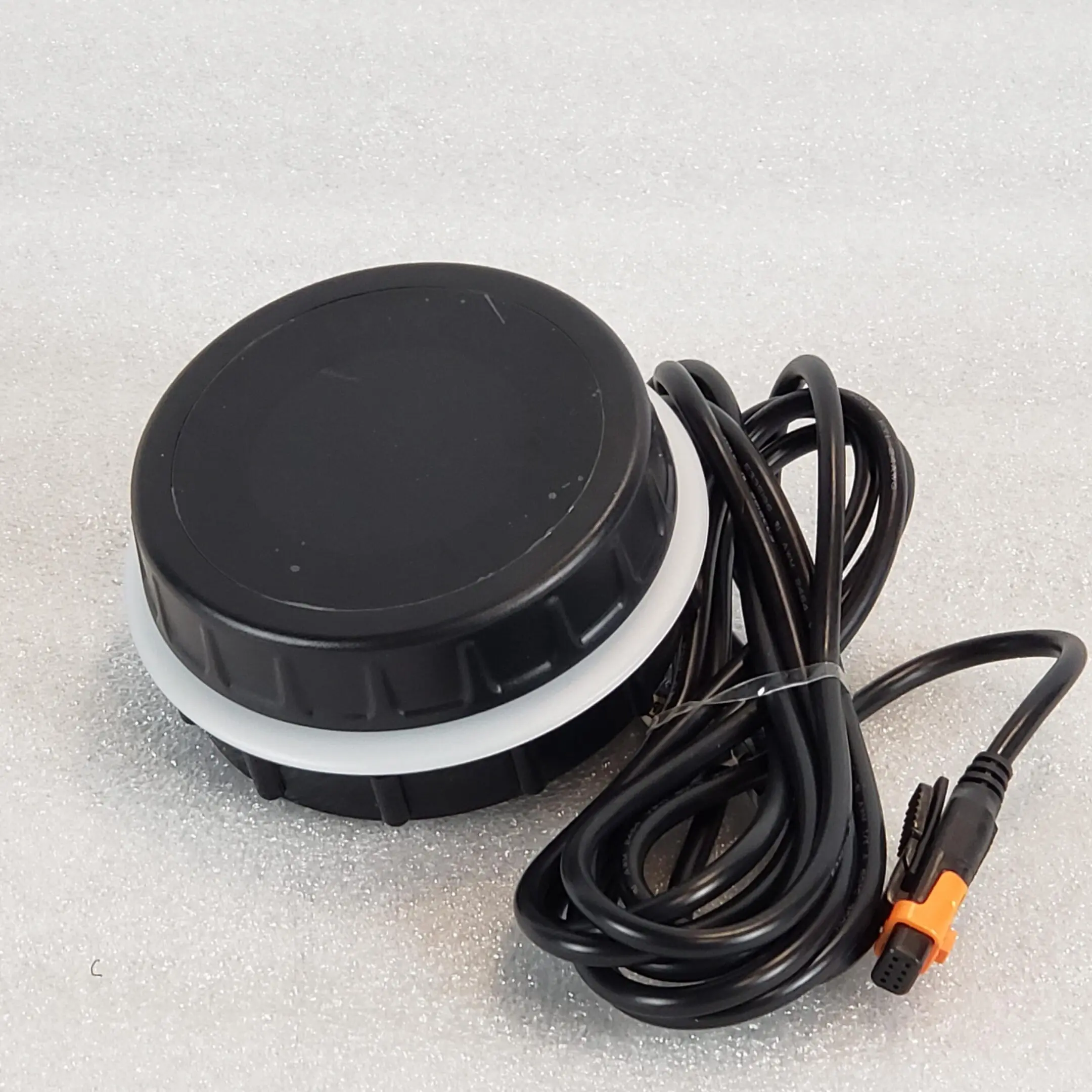A black and white picture of a button with wires.