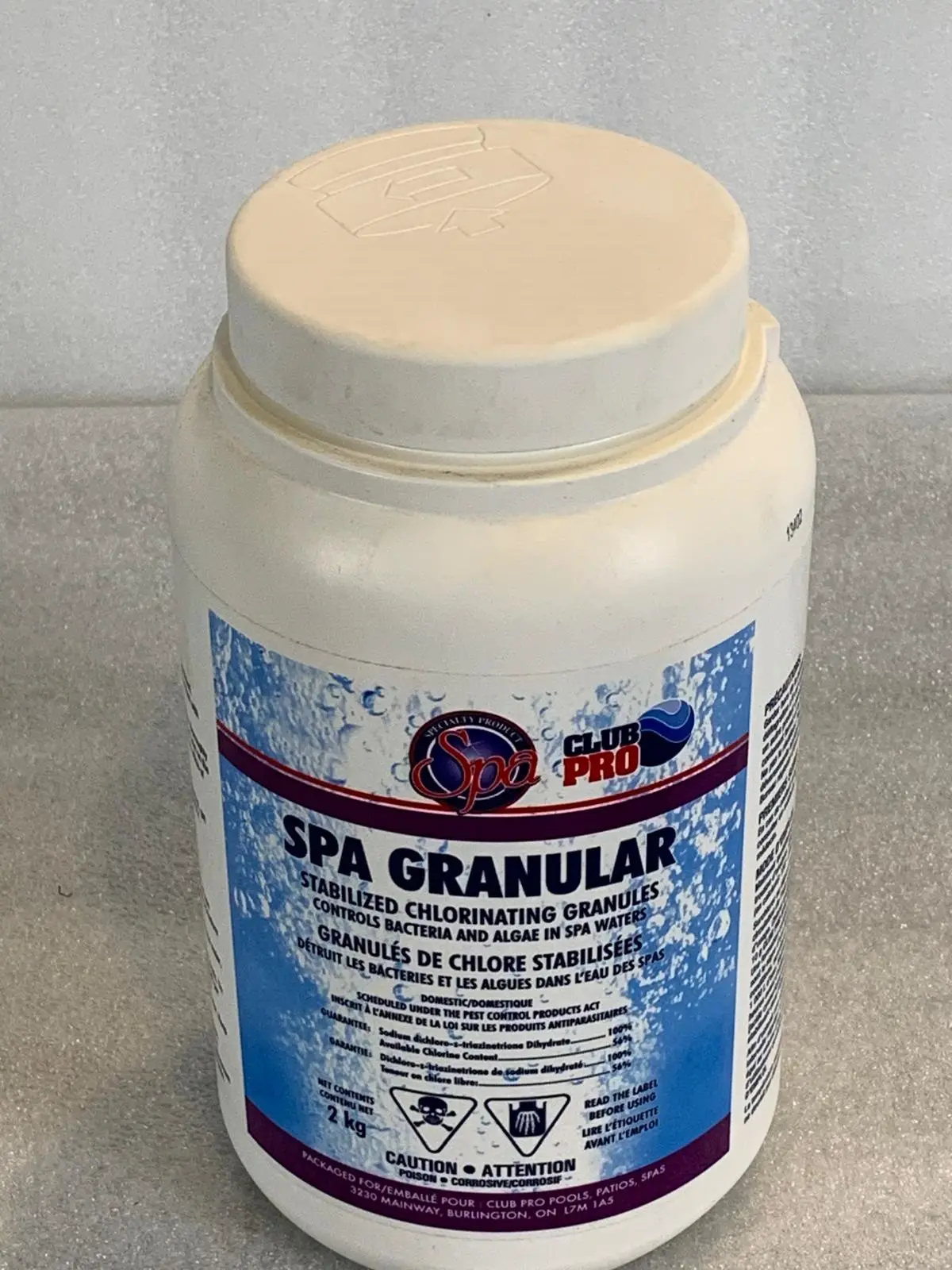 A tub of spa granular is sitting on the counter.