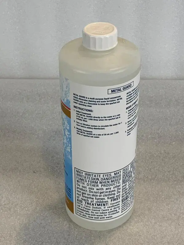 A bottle of liquid sitting on top of a counter.