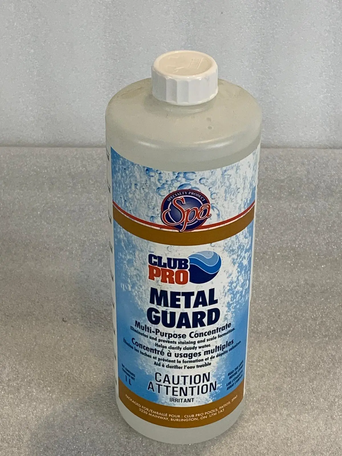 A bottle of metal guard is sitting on the floor.