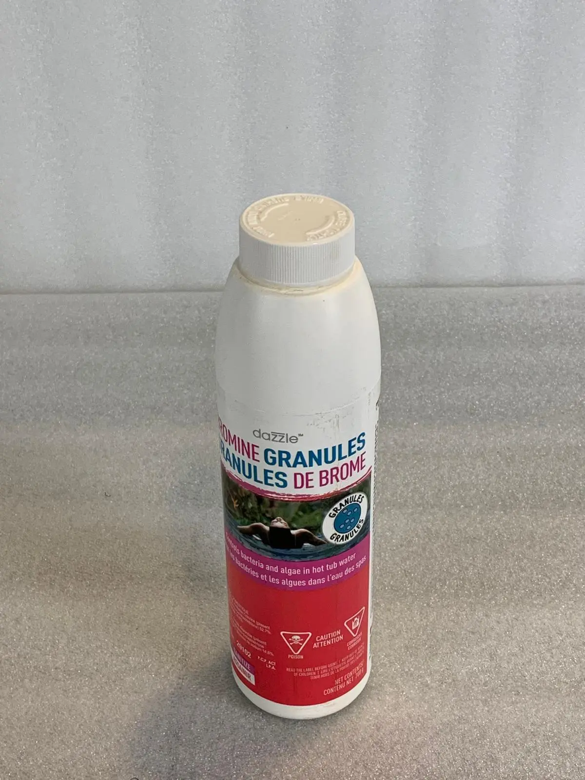 A bottle of cleaning product sitting on top of a counter.