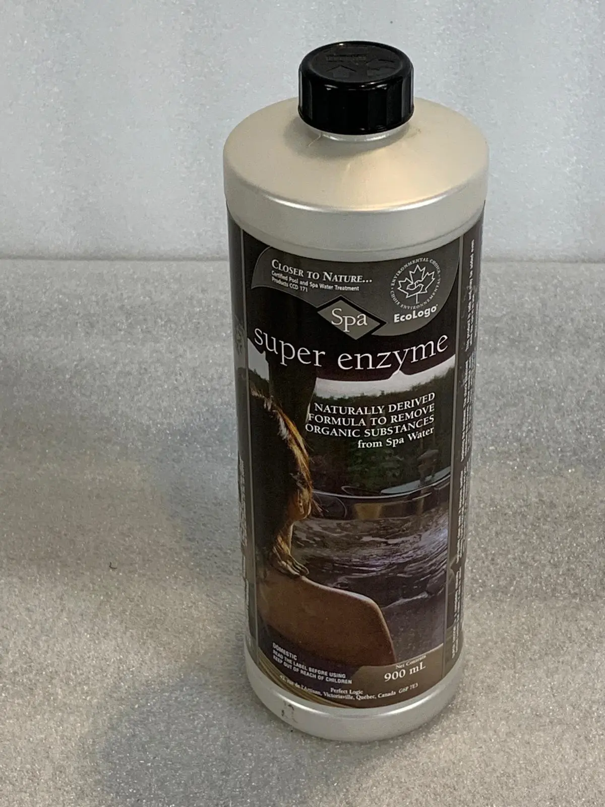 A bottle of liquid sitting on top of a counter.