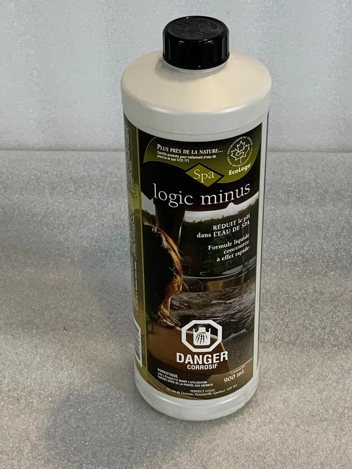 A bottle of liquid sitting on top of a counter.
