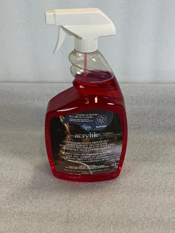 A red bottle of car wash soap sitting on top of a floor.