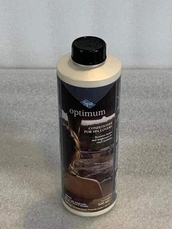 A bottle of optimum cleaner on top of a counter.