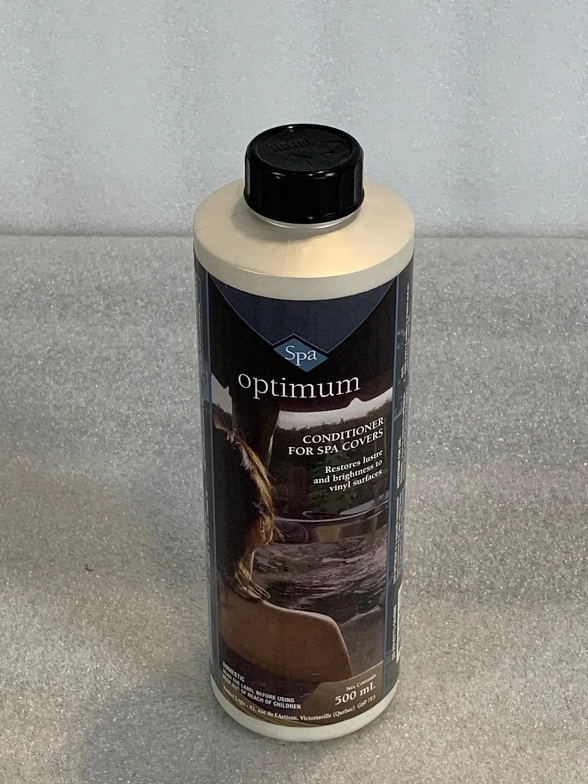 A bottle of optimum cleaner on top of a counter.