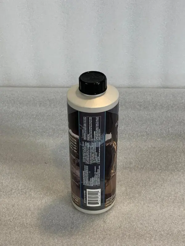 A bottle of car wax sitting on top of a counter.
