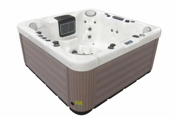 A hot tub with a remote control and speakers.
