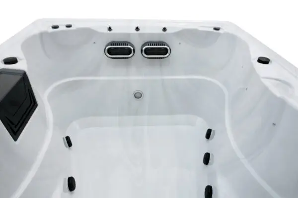 A white spa with two black jets and no cover.