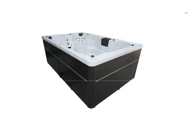 A black and white tub with a large space for people to sit in it.