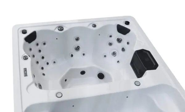 A white spa tub with black jets and handles.