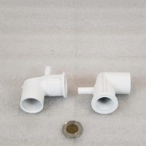 A pair of white plastic pipes sitting on top of a floor.