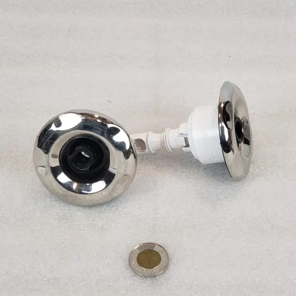 A pair of chrome knobs with a white knob.