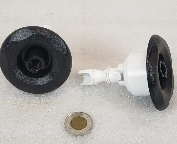 A black and white faucet with a penny