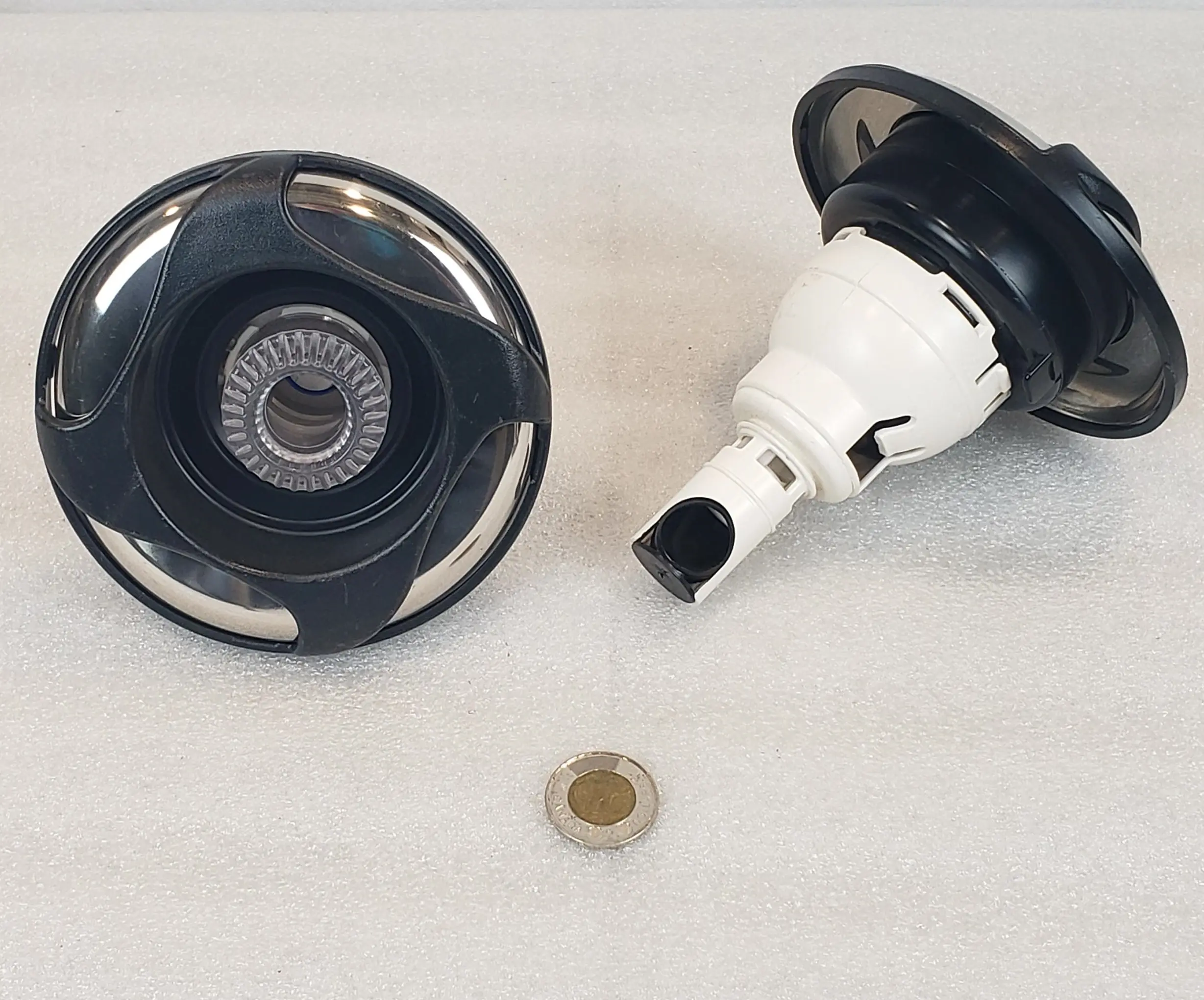 A white table with two black and silver objects.