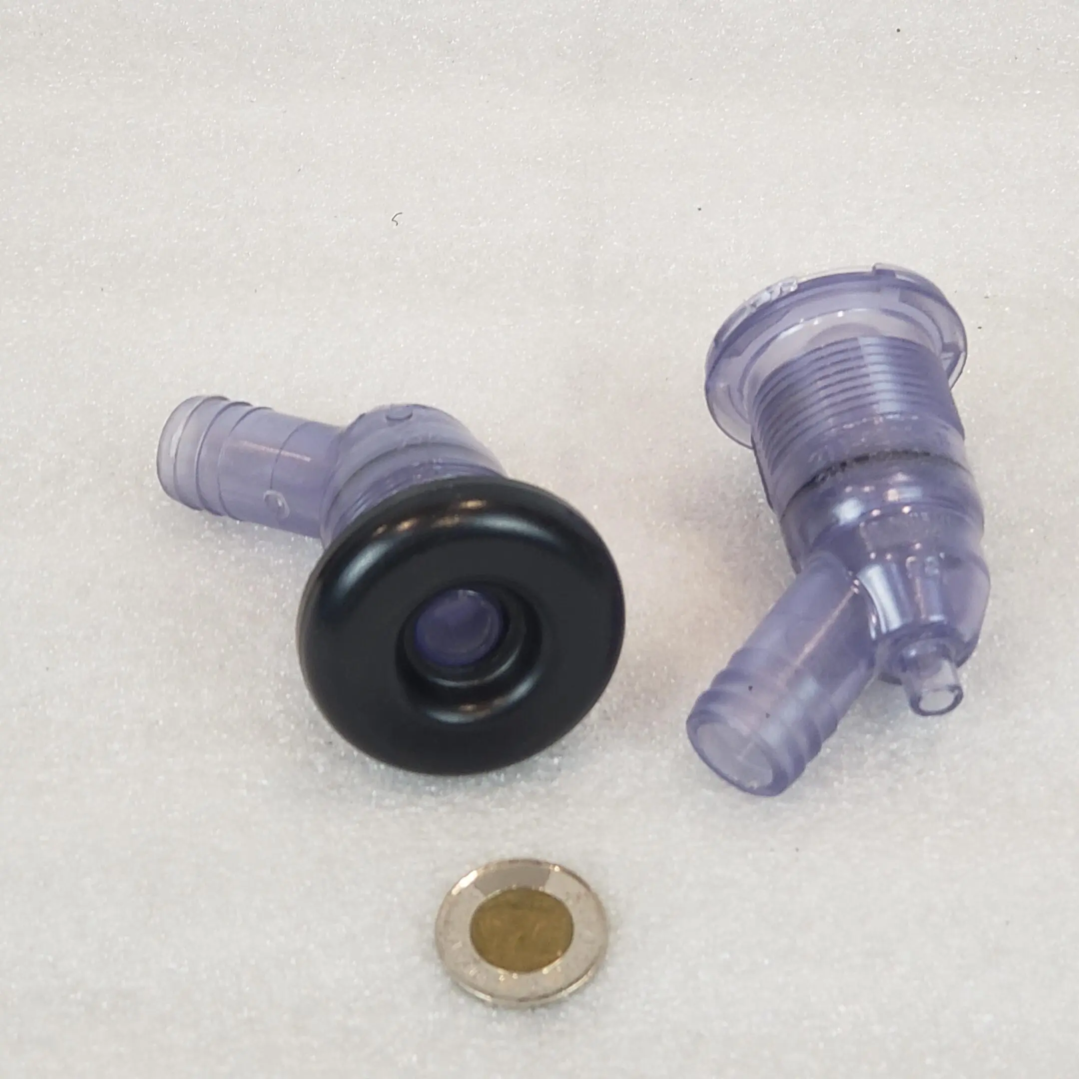 A black and purple plastic cap with two valves.