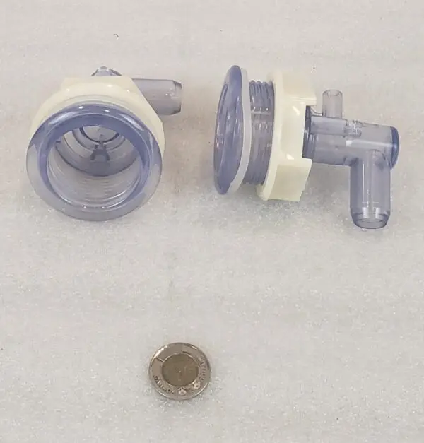 A close up of some plastic parts next to a coin