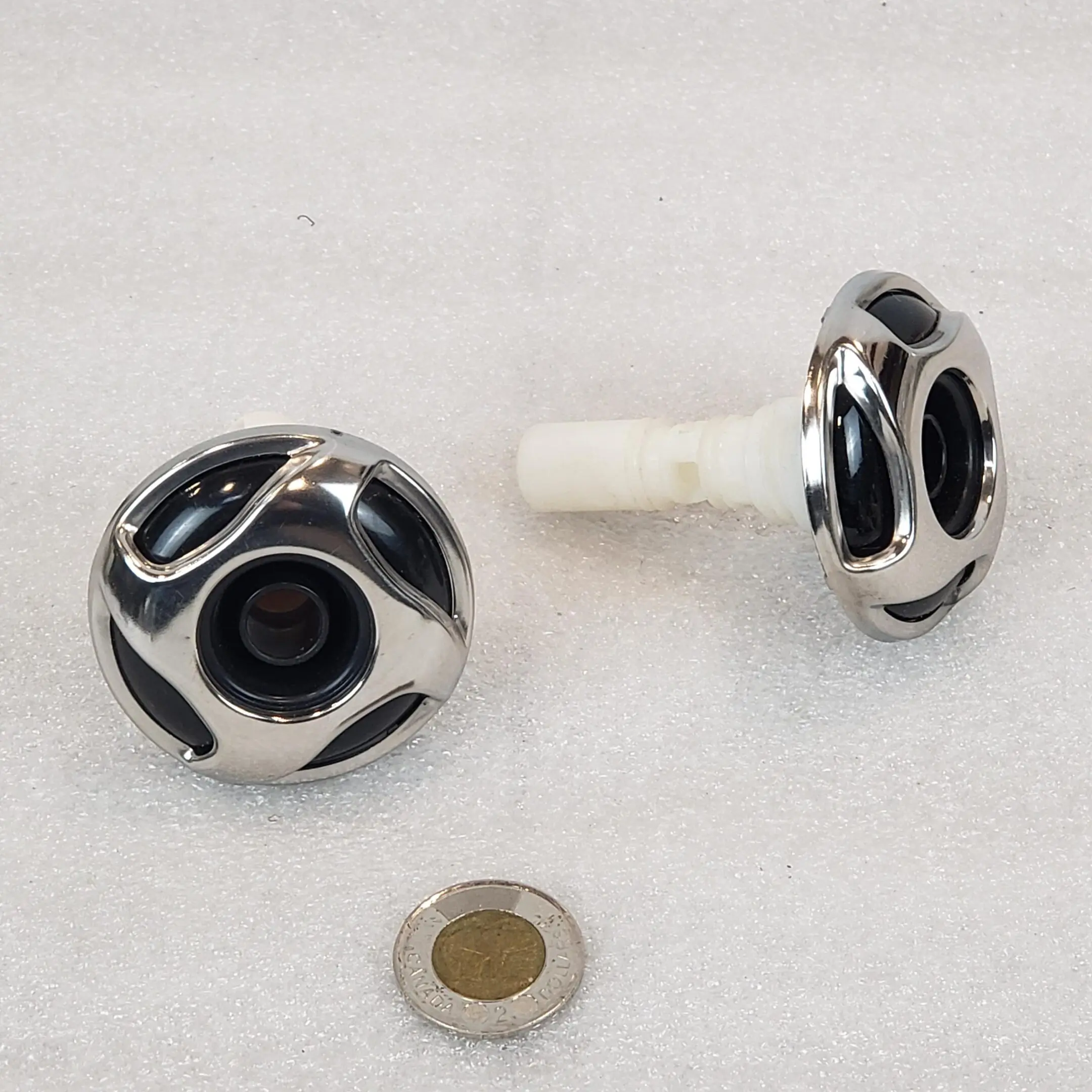 A pair of knobs with a metal ring on them.