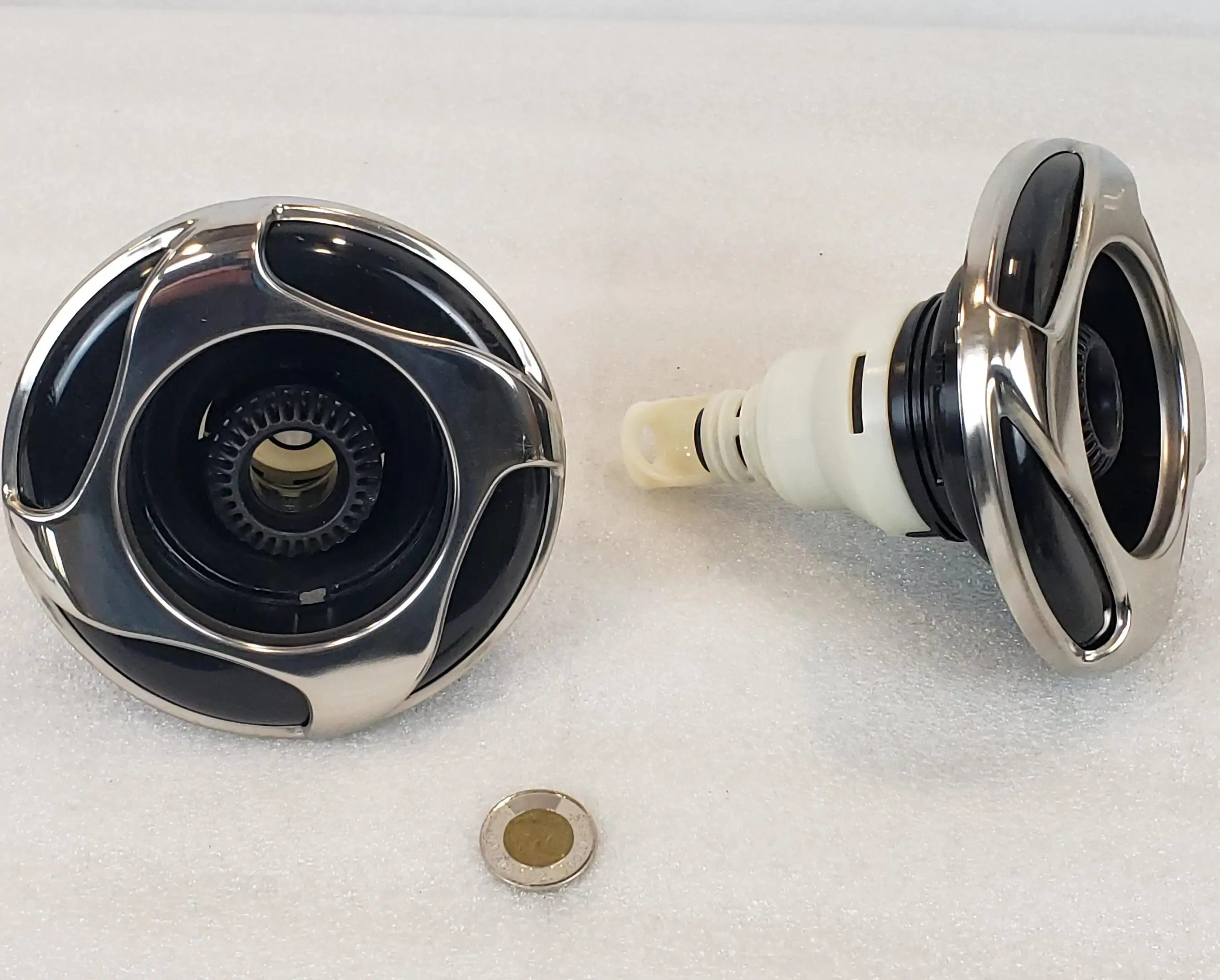 A close up of two knobs on the side of a table